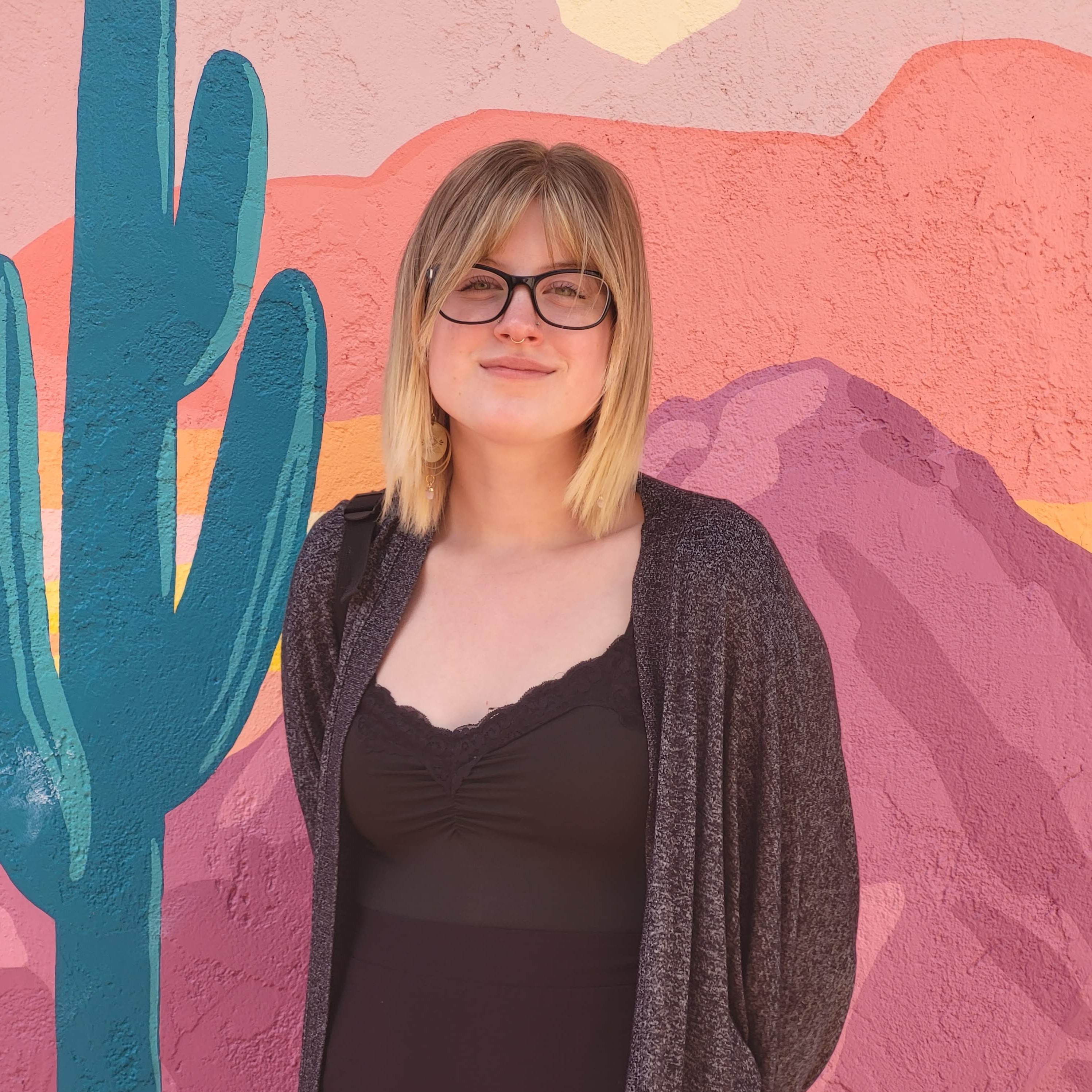 Picture of Keilynn standing in front of a colourful wall.